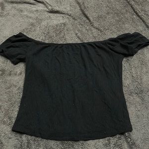 Off the shoulder black top. Size medium and stops below the belly button.